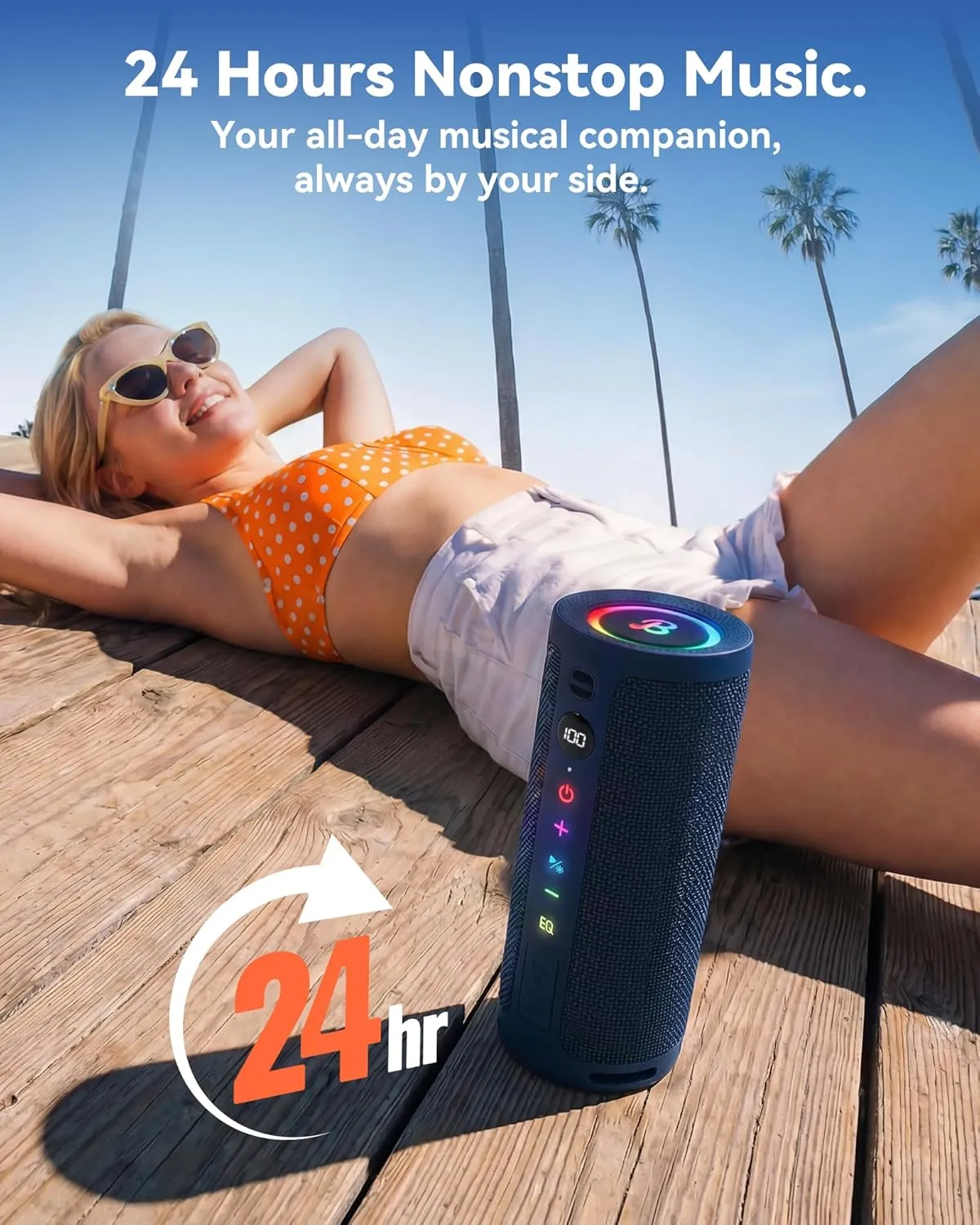 Person relaxing on a deck beside a blue BassBloom Roar 3 with all-day battery life