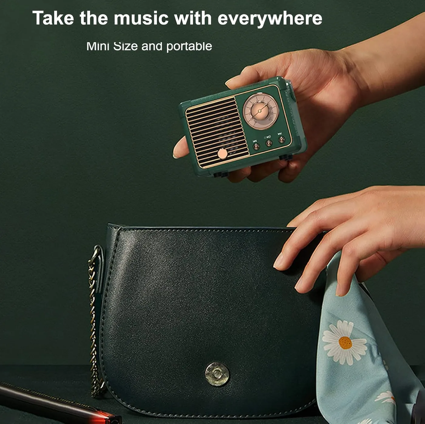 Hand holding the green Dosmix retro speaker above a handbag, showing its pocket-friendly portability