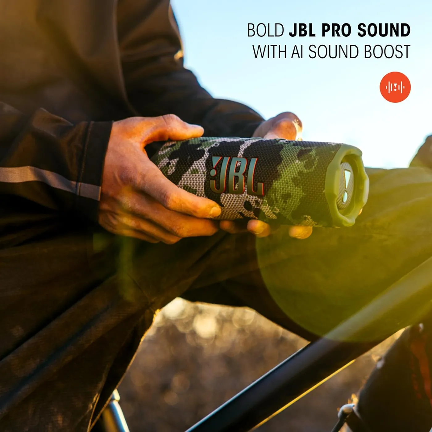 Hands holding the JBL Flip 7 outdoors with the 'Bold JBL Pro Sound with AI Sound Boost' marketing graphic