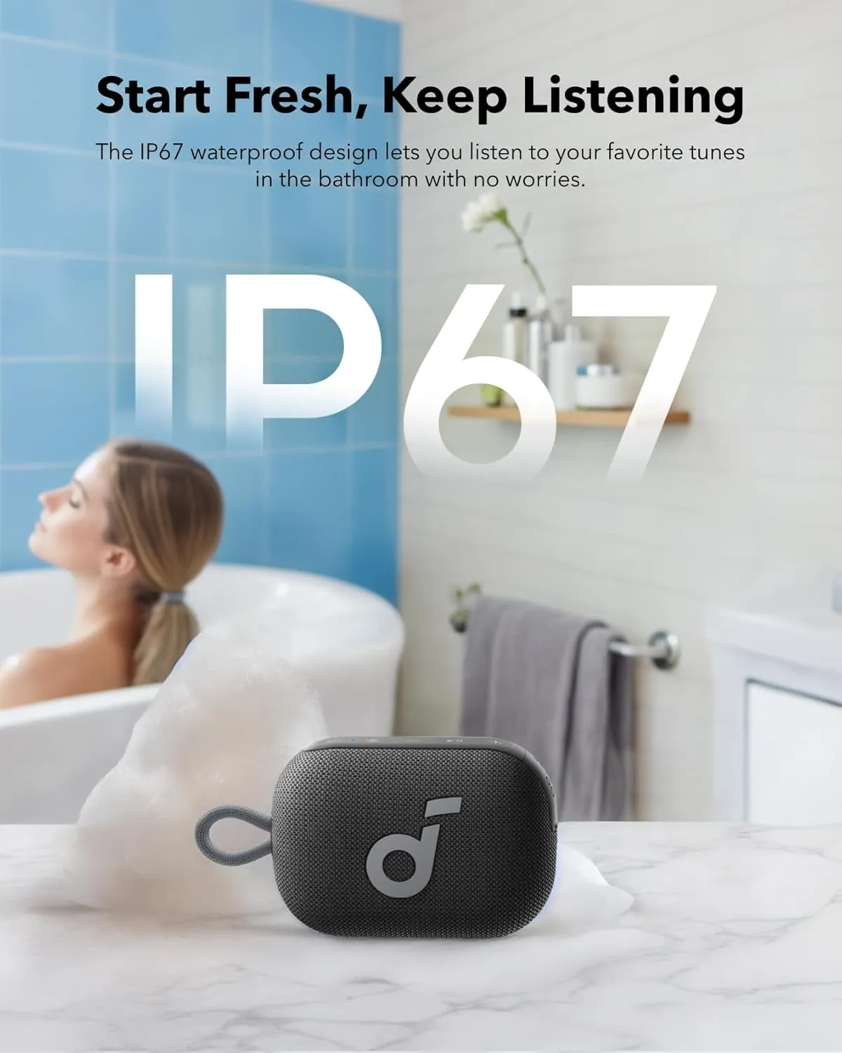 Soundcore Select 4 Go on a bathroom counter beside a bathtub, showing its IP67 waterproof rating for shower and bath use
