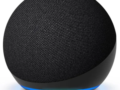 Charcoal Amazon Echo Dot smart speaker with its blue Alexa light ring lit, seen from the front