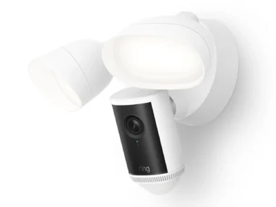 White Ring Floodlight Cam 4K Pro wall mount with both floodlights lit and the 4K camera pod angled downward