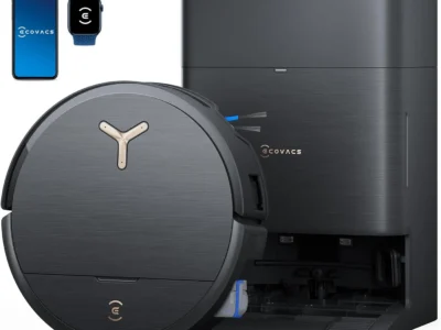 ECOVACS DEEBOT X9 PRO Omni Robot Vacuum and Mop in black, angled in front of its dock, with phone and watch