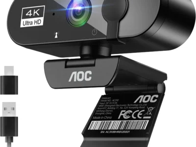 AOC AC310 4K webcam three-quarter view with sliding lens cover, clip stand, USB-A cable and USB-C adapter