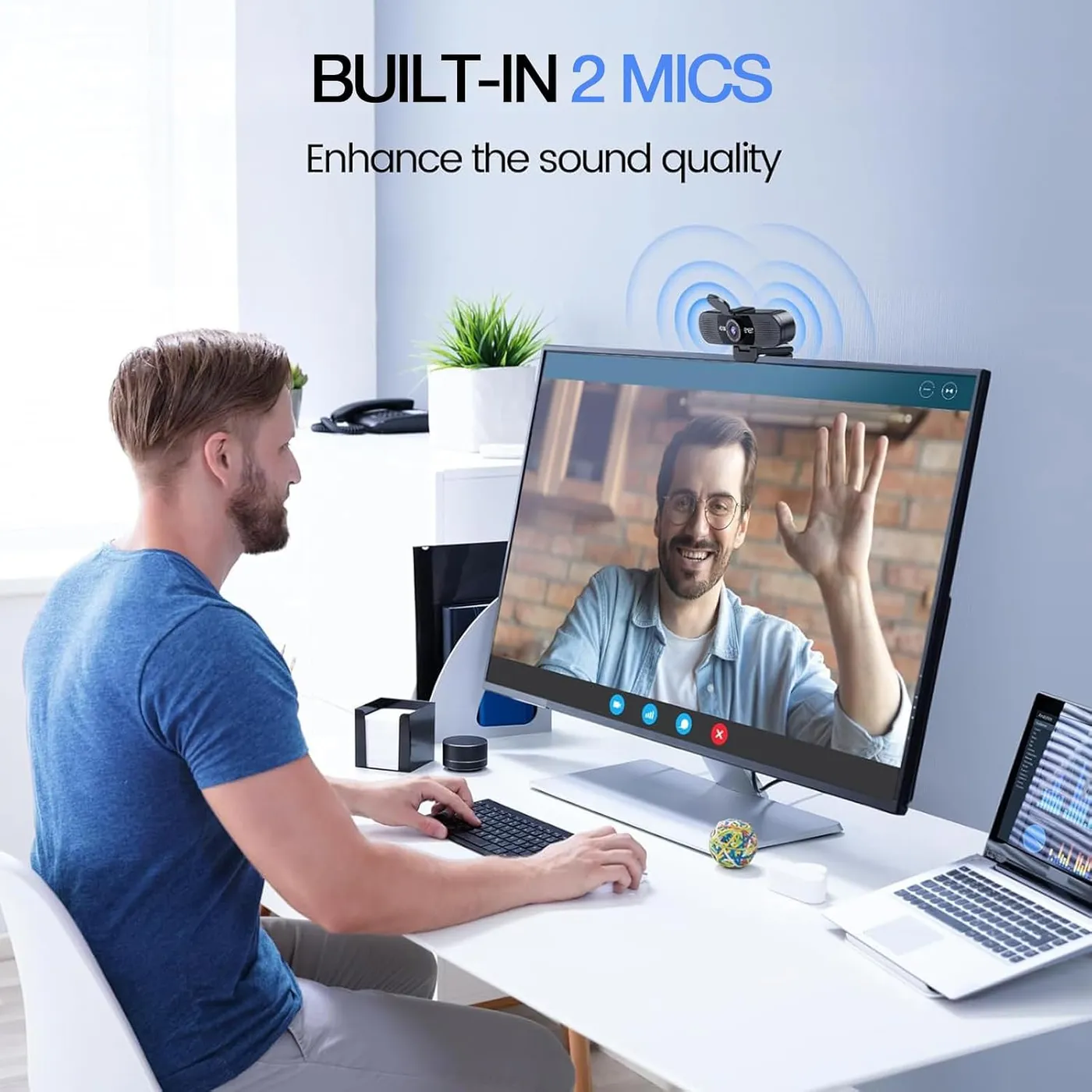 EMEET C960 1080P webcam on a desk monitor during a video call, a man waving at the screen, built-in 2 mics callout