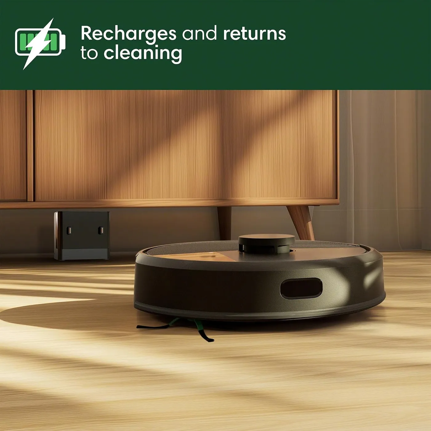 iRobot Roomba 105 Vac on a hardwood floor with its small charging base behind it, recharge-and-resume claim