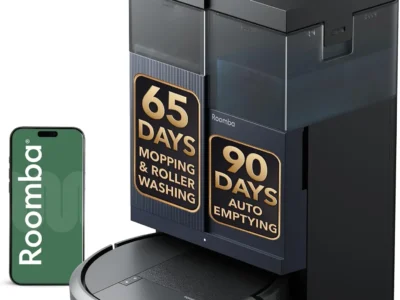 iRobot Roomba 415X black robot vacuum docked at its dual-tank station beside a phone, with 65-day and 90-day claim badges