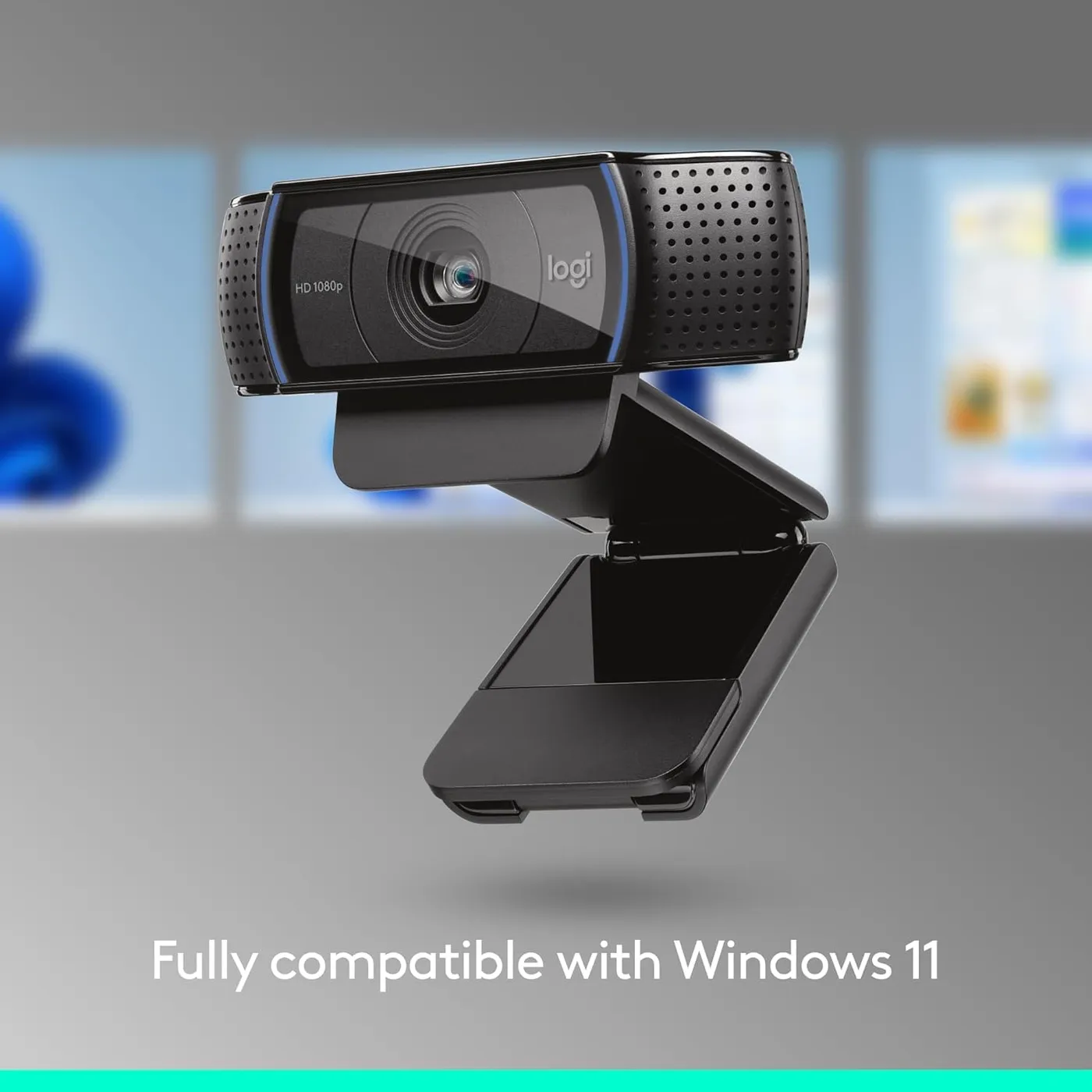 Logitech C920x HD Pro webcam floating in front of blurred Windows desktop windows, Windows 11 compatibility caption
