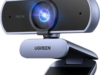 UGREEN 2K Webcam in grey and black with the lens privacy cover flipped up, on a clip stand